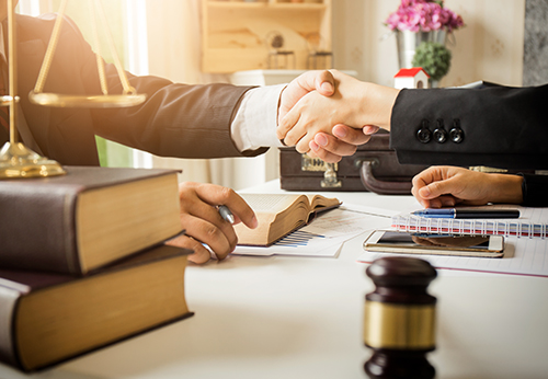 Divorce lawyer in Lake Bluff IL shaking hands with client in office setting